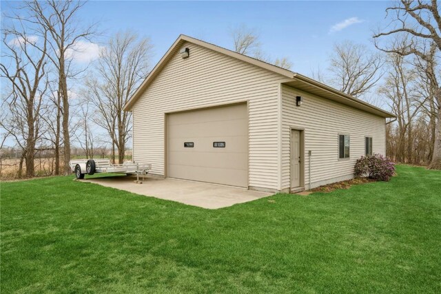 view of home's exterior with an outdoor structure, a garage, and a yard