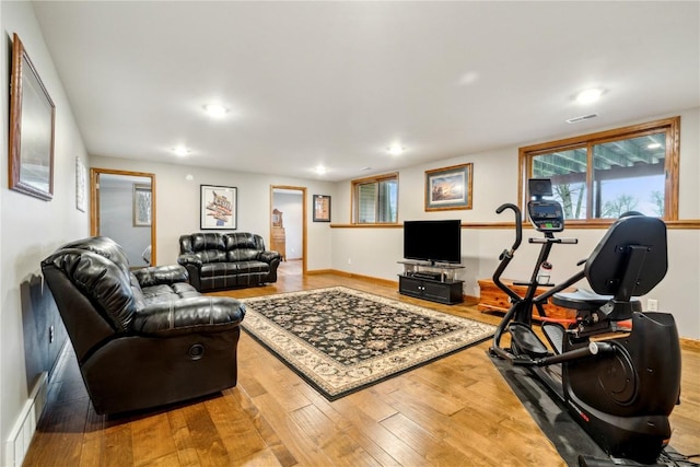 living room with wood finished floors, recessed lighting, and baseboards