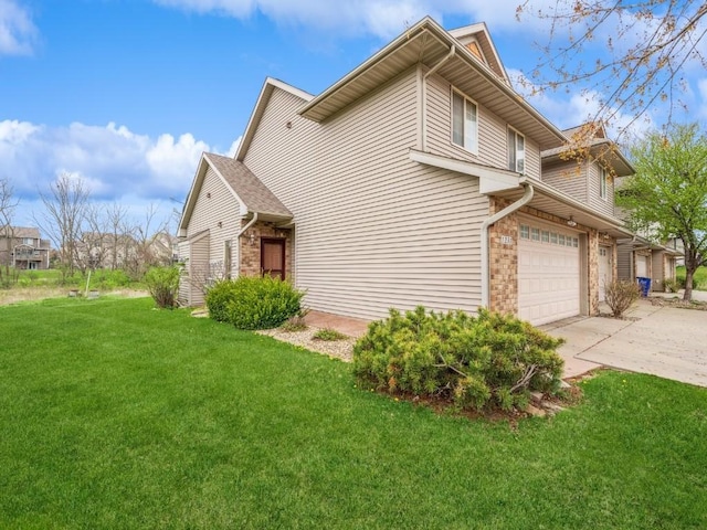 view of side of home with brick siding, driveway, and a lawn