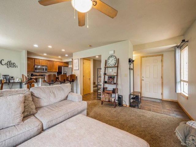 living room featuring a ceiling fan, baseboards, and recessed lighting