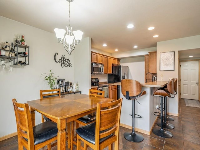 dining area featuring baseboards, a notable chandelier, dark tile patterned flooring, and recessed lighting