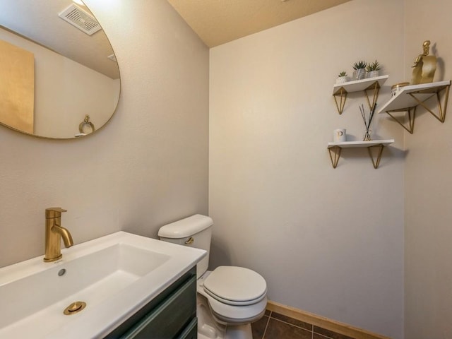 bathroom featuring toilet, baseboards, visible vents, tile patterned flooring, and vanity