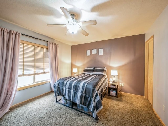 bedroom featuring a ceiling fan, baseboards, and carpet floors