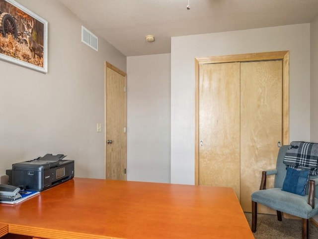 home office featuring carpet floors and visible vents