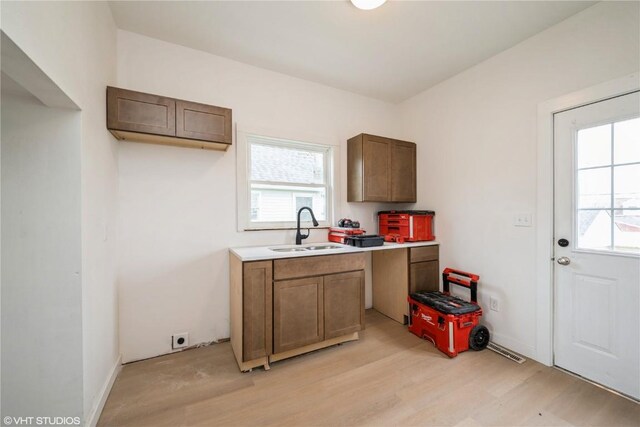 802 22nd Ave SW, Cedar Rapids, IA 52404 - washroom with a sink and light wood-style floors