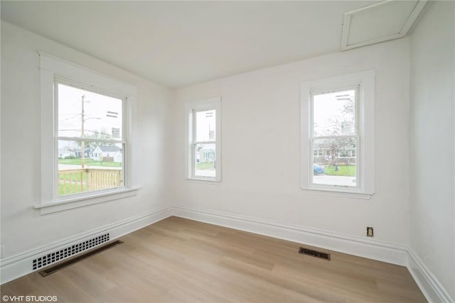 802 22nd Ave SW, Cedar Rapids, IA 52404 - unfurnished room with wood finished floors and attic access