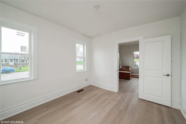 802 22nd Ave SW, Cedar Rapids, IA 52404 - unfurnished room with healthy amount of natural light, light wood-style floors, and attic access