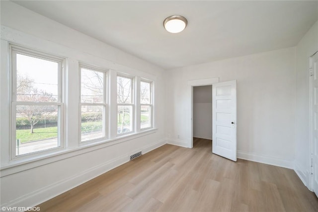 802 22nd Ave SW, Cedar Rapids, IA 52404 - unfurnished bedroom featuring light wood finished floors and multiple windows