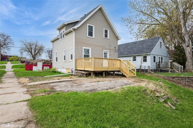 802 22nd Ave SW, Cedar Rapids, IA 52404 - rear view of house featuring a wooden deck and a lawn