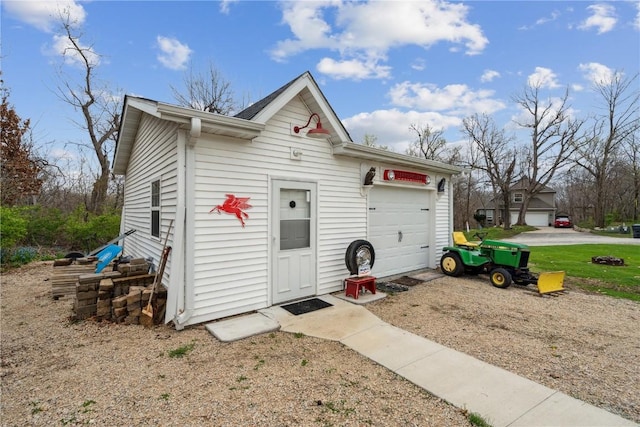 view of outbuilding with an attached garage and an outdoor structure