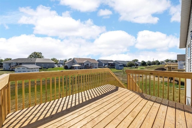 wooden terrace featuring a yard and a residential view