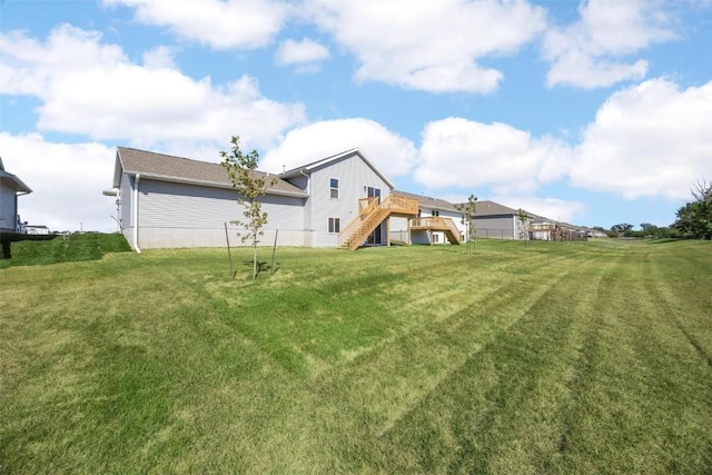 view of yard featuring stairway and a deck