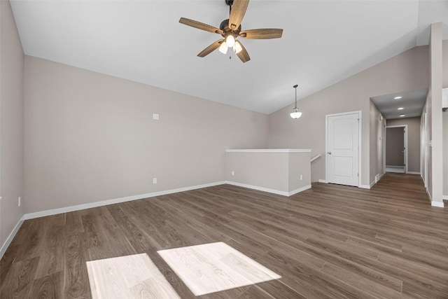 spare room with lofted ceiling, wood finished floors, baseboards, and ceiling fan