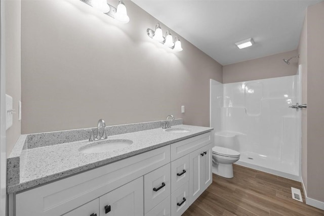 bathroom featuring walk in shower, visible vents, a sink, and toilet