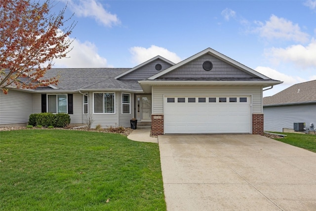 3211 35th Ave, Marion, IA 52302 - ranch-style house with brick siding, a front yard, cooling unit, and a garage