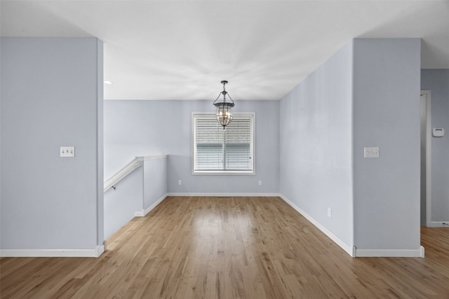 3211 35th Ave, Marion, IA 52302 - unfurnished dining area featuring baseboards, a notable chandelier, and wood finished floors