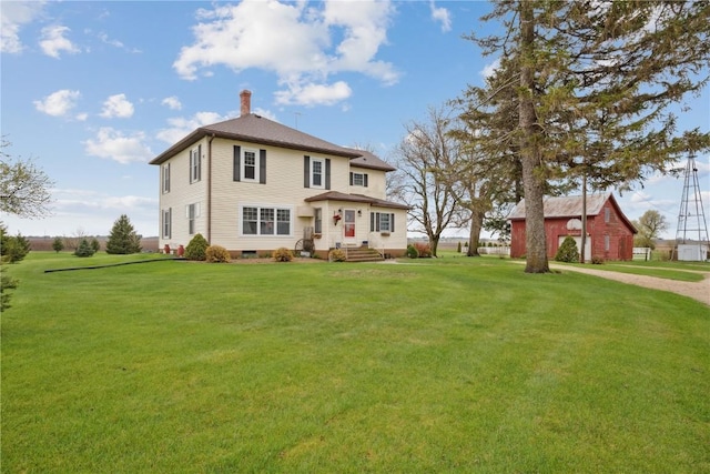 rear view of property with a chimney and a lawn