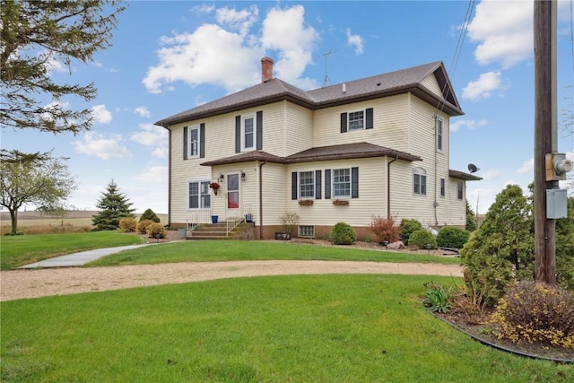 19979 200th Ave, Monticello, IA 52310 - back of house featuring a chimney and a yard