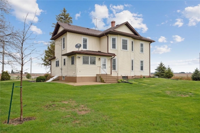 19979 200th Ave, Monticello, IA 52310 - rear view of house featuring a chimney and a lawn