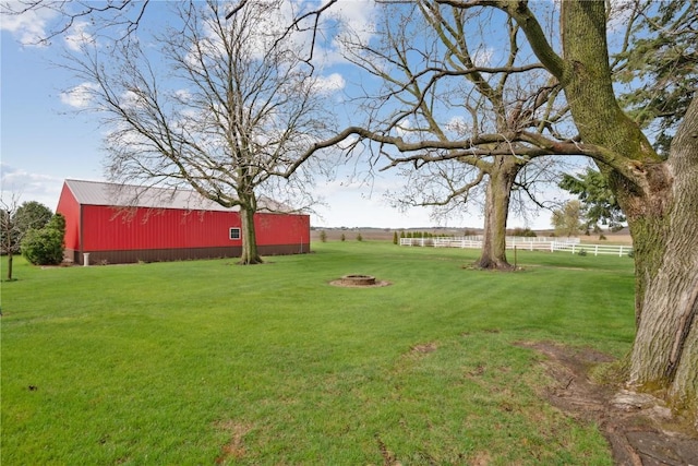 view of yard featuring an outbuilding and fence