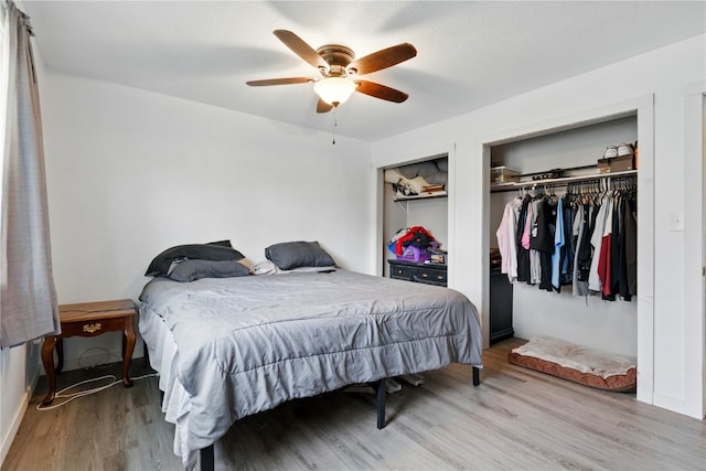 404 Main St, Shellsburg, IA 52332 - bedroom featuring a ceiling fan, multiple closets, and wood finished floors