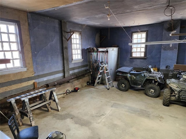 interior space featuring unfinished concrete flooring and plenty of natural light