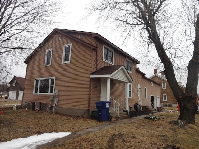 rear view of property with central AC
