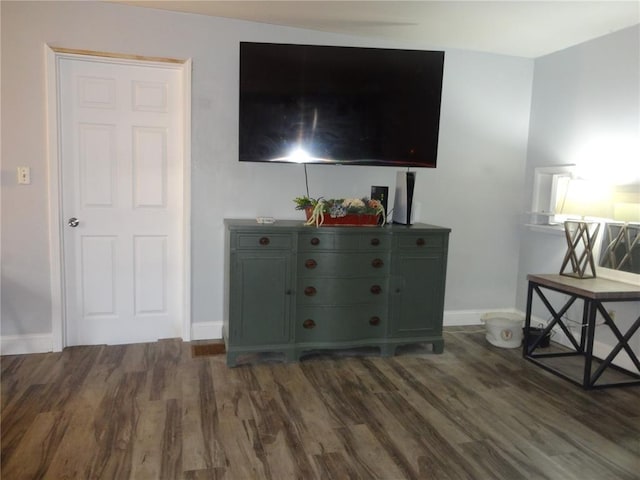 interior space with wood finished floors and baseboards