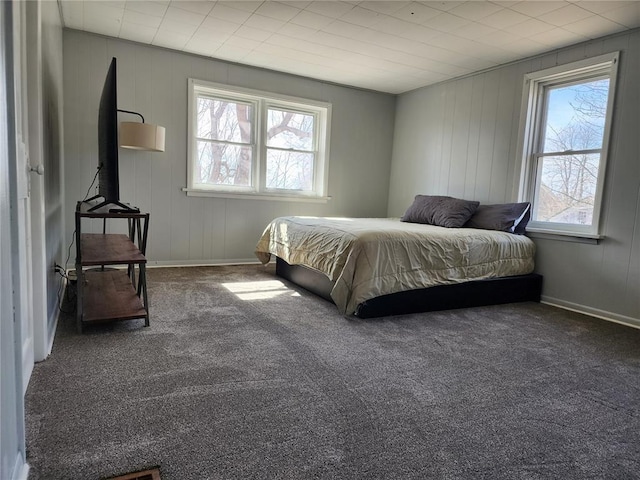 carpeted bedroom with baseboards and multiple windows