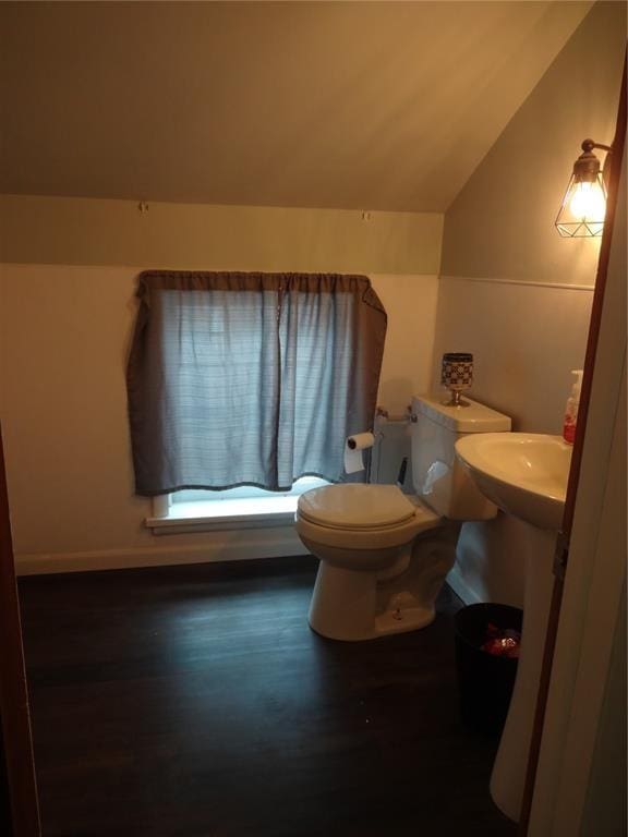 bathroom featuring toilet, vaulted ceiling, and wood finished floors