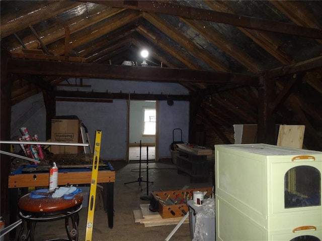 unfinished attic featuring washer / dryer