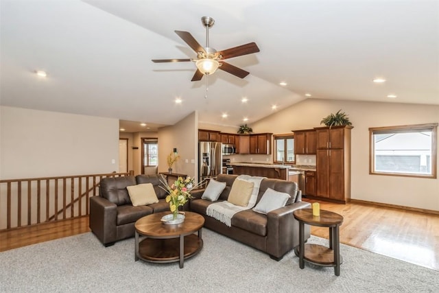 living room featuring recessed lighting, light wood-style flooring, vaulted ceiling, light carpet, and ceiling fan