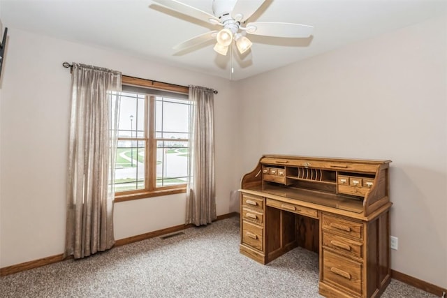 home office with a ceiling fan, visible vents, light colored carpet, and baseboards