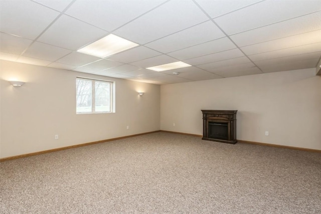 below grade area with light carpet and baseboards