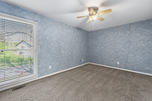 1156 Cambria Ct, Iowa City, IA 52246 - carpeted empty room with visible vents, ceiling fan, and a healthy amount of sunlight