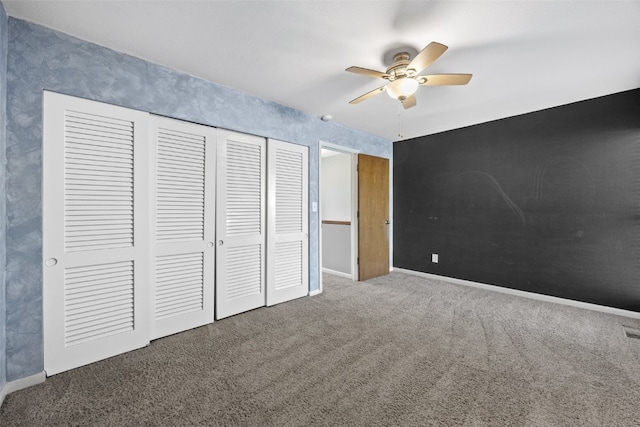1156 Cambria Ct, Iowa City, IA 52246 - unfurnished bedroom featuring a closet, ceiling fan, carpet, and baseboards