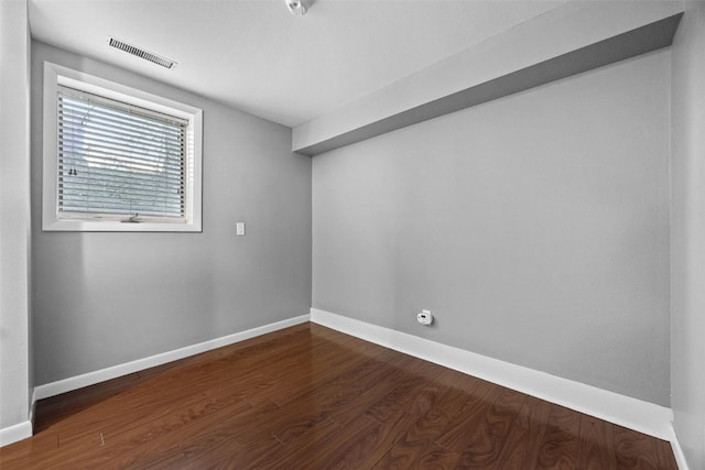 1156 Cambria Ct, Iowa City, IA 52246 - unfurnished room with dark wood-style flooring, visible vents, and baseboards