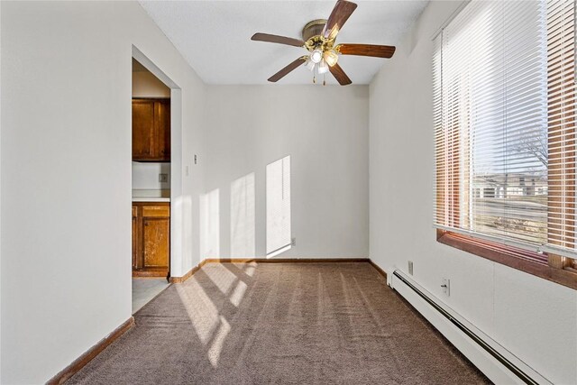 3212 Wilson Ave SW, Cedar Rapids, IA 52404 - carpeted empty room with baseboard heating, ceiling fan, and baseboards