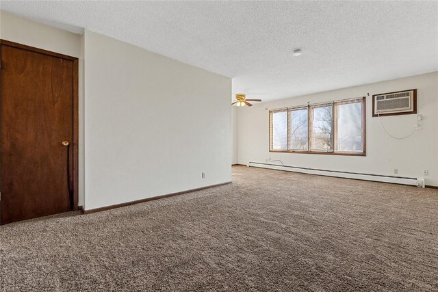 3212 Wilson Ave SW, Cedar Rapids, IA 52404 - spare room featuring a baseboard heating unit, an AC wall unit, carpet, a textured ceiling, and baseboards