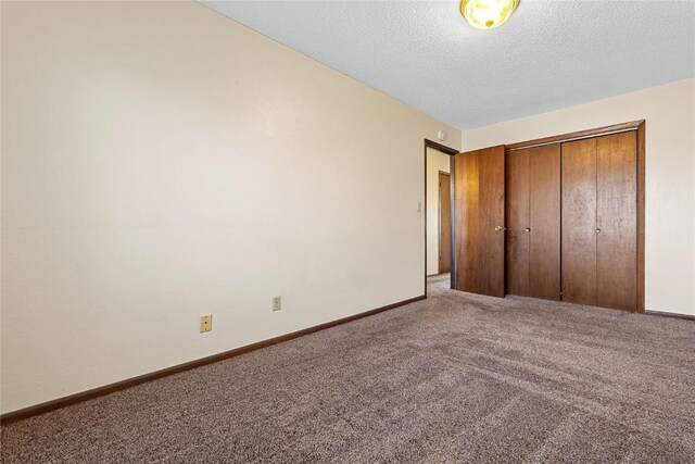 3212 Wilson Ave SW, Cedar Rapids, IA 52404 - unfurnished bedroom featuring carpet flooring, a textured ceiling, a closet, and baseboards