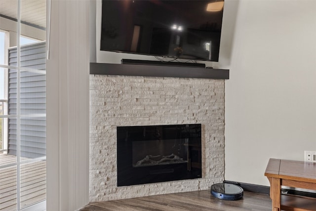 interior details featuring a fireplace and wood finished floors