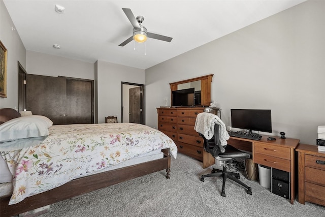 bedroom with a ceiling fan and light carpet