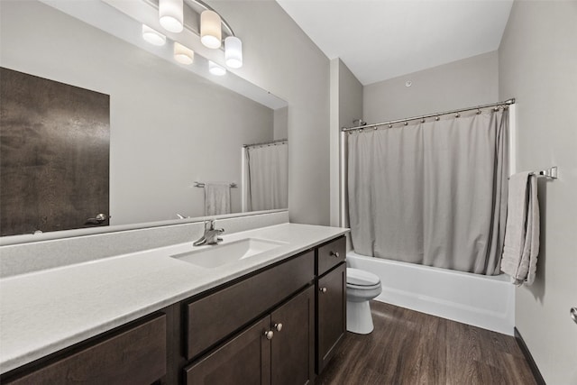 bathroom featuring shower / bathtub combination with curtain, wood finished floors, toilet, and vanity
