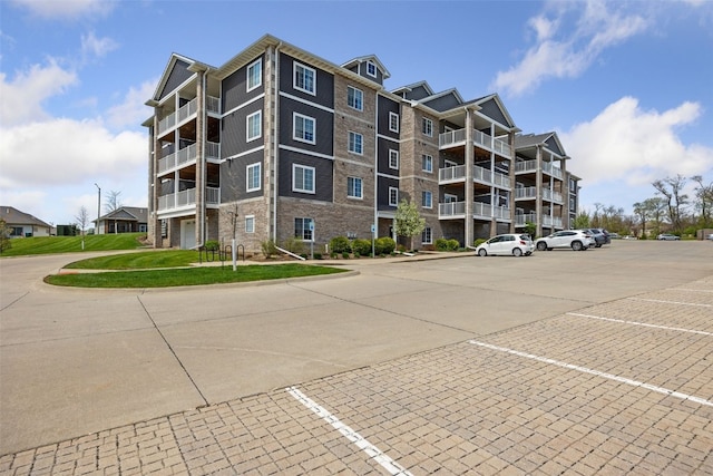 view of building exterior with uncovered parking