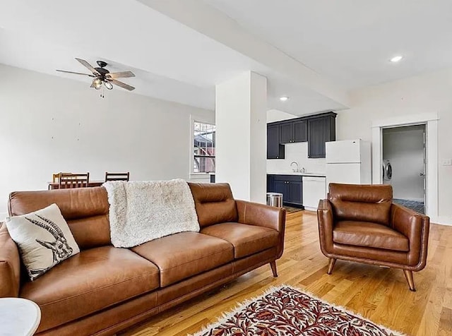 living room with recessed lighting, washer / clothes dryer, a ceiling fan, and light wood-style flooring