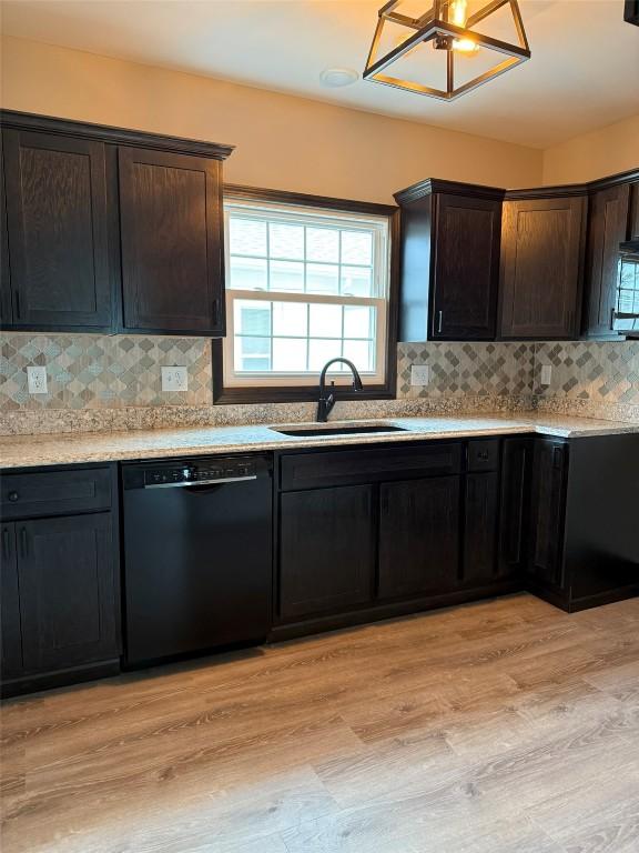 305 E 5th St, Vinton, IA 52349 - kitchen with a sink, light wood-style flooring, dishwasher, and a wealth of natural light