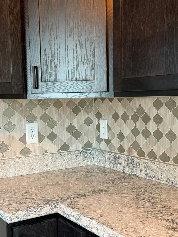 305 E 5th St, Vinton, IA 52349 - kitchen with dark brown cabinetry, light countertops, and backsplash