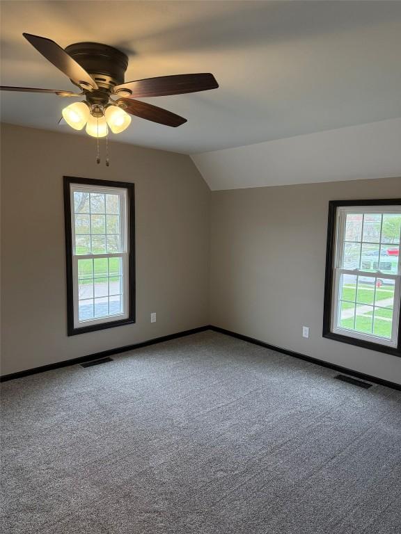 305 E 5th St, Vinton, IA 52349 - bonus room with visible vents, plenty of natural light, vaulted ceiling, and carpet floors
