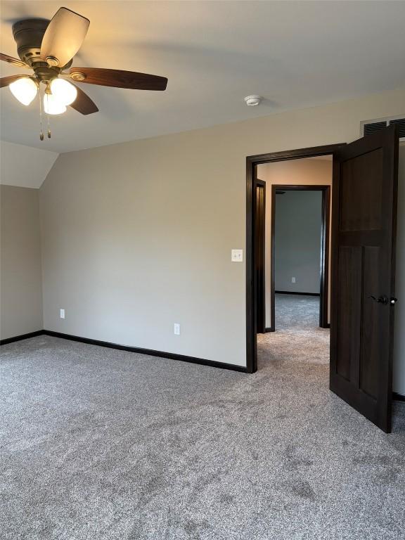 305 E 5th St, Vinton, IA 52349 - spare room featuring ceiling fan, carpet floors, and baseboards