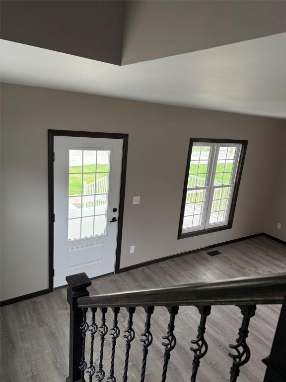 305 E 5th St, Vinton, IA 52349 - entrance foyer featuring baseboards, visible vents, and wood finished floors